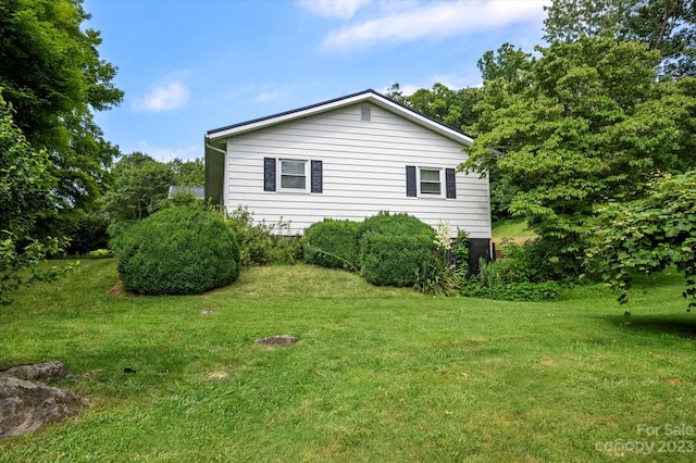 view of side of property with a lawn