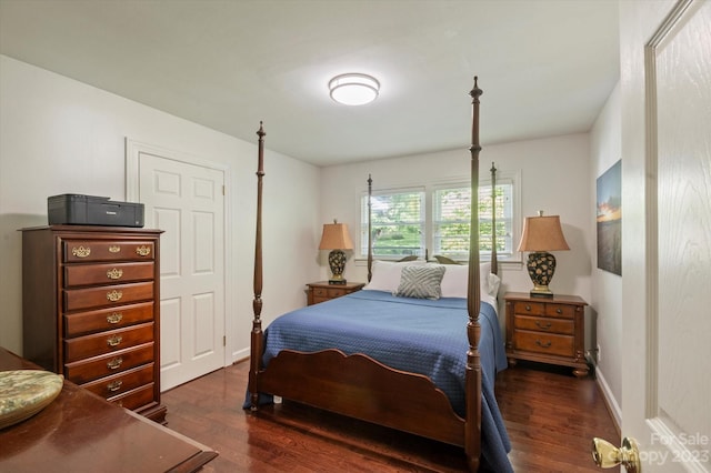 bedroom with dark hardwood / wood-style floors