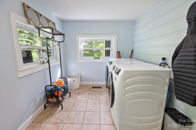 washroom featuring light tile floors and separate washer and dryer