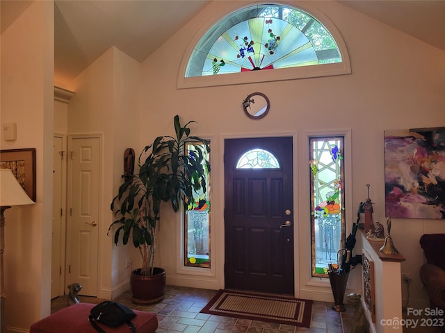 tiled entryway with high vaulted ceiling