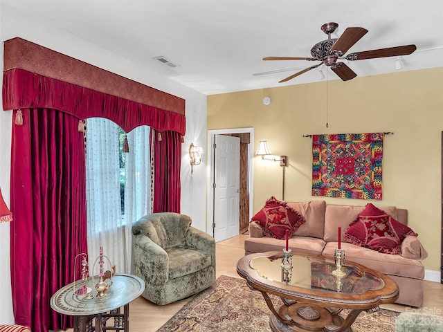 living room featuring light hardwood / wood-style flooring and ceiling fan