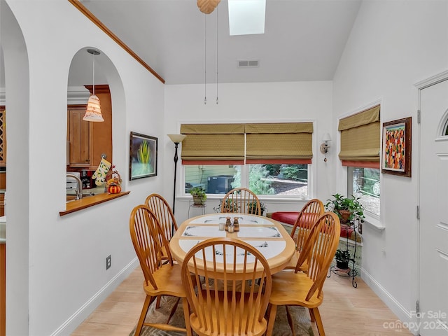 dining space with ceiling fan and light wood-type flooring