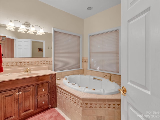 bathroom with tiled tub and vanity