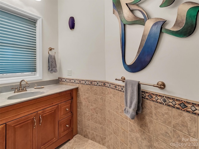 bathroom featuring tile walls, vanity with extensive cabinet space, and tile flooring