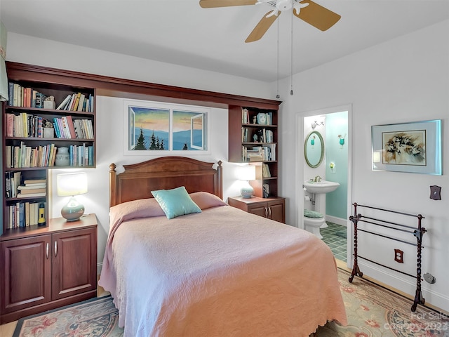 bedroom with connected bathroom, sink, ceiling fan, and light hardwood / wood-style flooring