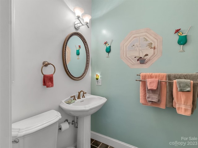 bathroom featuring toilet and tile floors