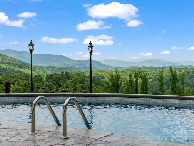 view of swimming pool featuring a mountain view