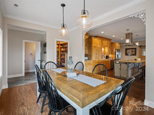 dining area with ornamental molding and sink