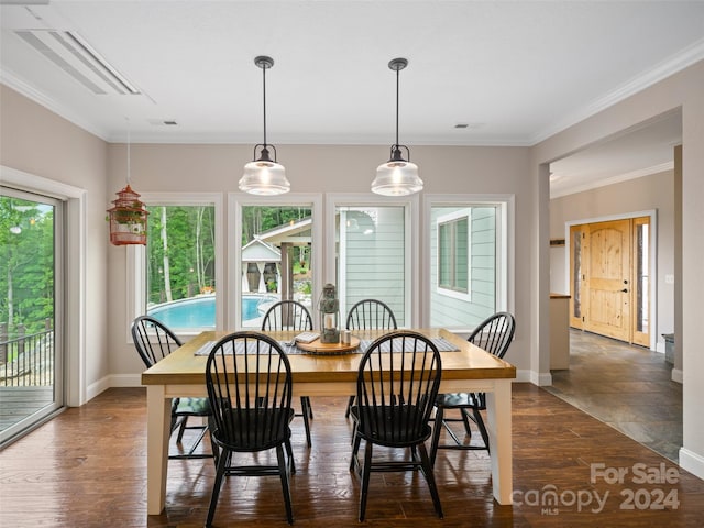 dining area with dark wood-type flooring and ornamental molding