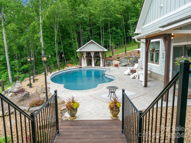 view of pool featuring an outbuilding and a patio