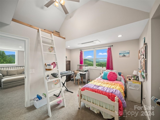 bedroom with multiple windows, ceiling fan, carpet floors, and lofted ceiling