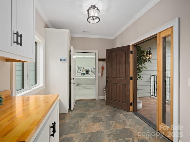 1590 S 226th Hwy, Bakersville, NC 28705 - entryway with stone finish flooring, ornamental molding, and visible vents