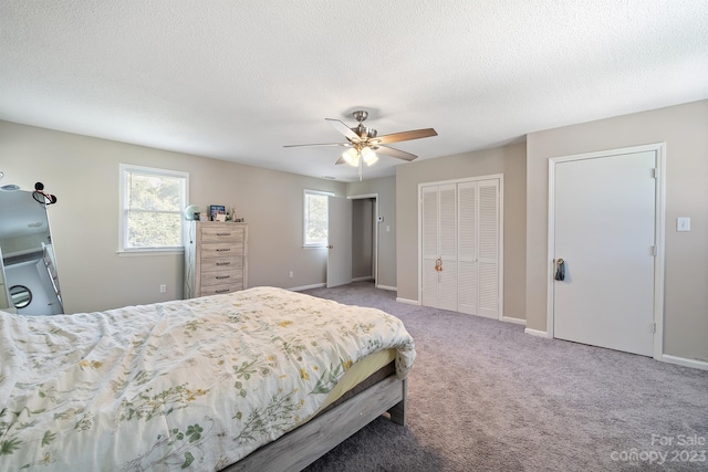 bedroom featuring carpet, ceiling fan, and a textured ceiling