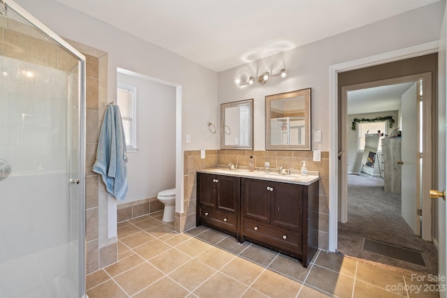 bathroom with toilet, dual vanity, tasteful backsplash, walk in shower, and tile flooring