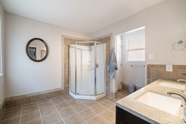 bathroom featuring walk in shower, dual sinks, tile flooring, and oversized vanity