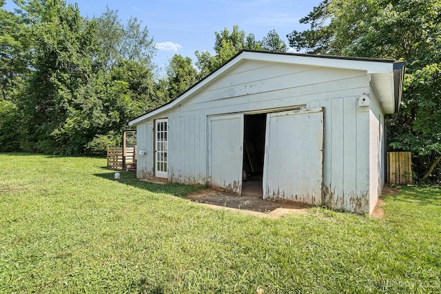 view of outdoor structure featuring a lawn