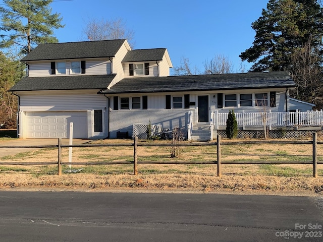 view of property with a front yard and a garage