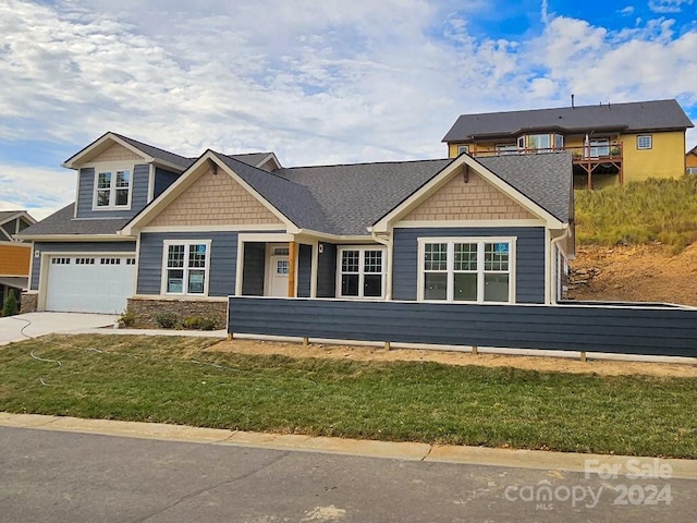 view of front of home featuring a garage and a front yard