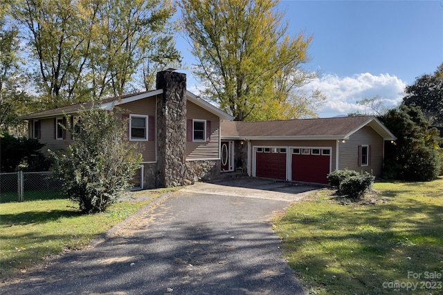 view of front of house with a front lawn and a garage