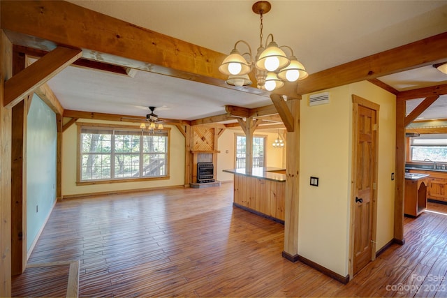 interior space featuring plenty of natural light, hanging light fixtures, and light hardwood / wood-style flooring