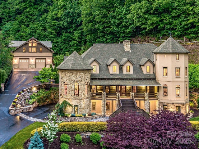 202 Emerald Ln, Maggie Valley, NC 28751 - view of front of house featuring stairway, a chimney, stone siding, a detached garage, and an outdoor structure