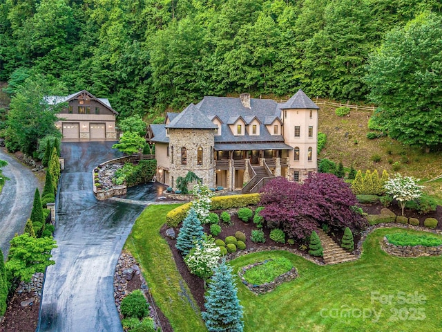 202 Emerald Ln, Maggie Valley, NC 28751 - view of front facade featuring stairs, an outbuilding, stone siding, a chimney, and driveway