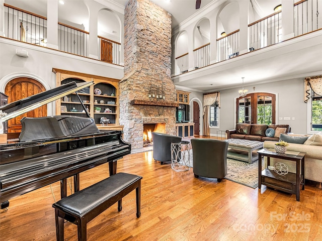 202 Emerald Ln, Maggie Valley, NC 28751 - living room featuring a fireplace, crown molding, a towering ceiling, wood finished floors, and recessed lighting