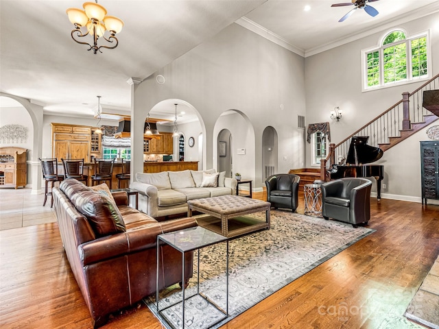 202 Emerald Ln, Maggie Valley, NC 28751 - living area with arched walkways, a chandelier, wood finished floors, ceiling fan, and baseboards
