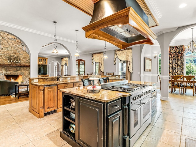 202 Emerald Ln, Maggie Valley, NC 28751 - kitchen featuring double oven range, crown molding, light tile patterned flooring, a center island, and island range hood