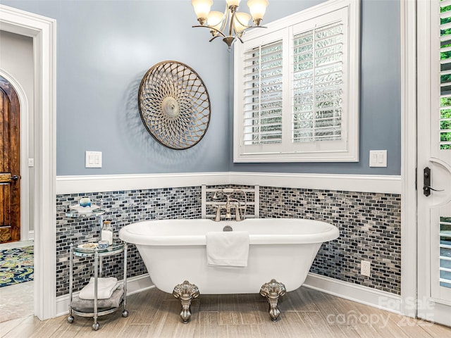 202 Emerald Ln, Maggie Valley, NC 28751 - bathroom with tile walls, wainscoting, a soaking tub, a chandelier, and tile patterned flooring