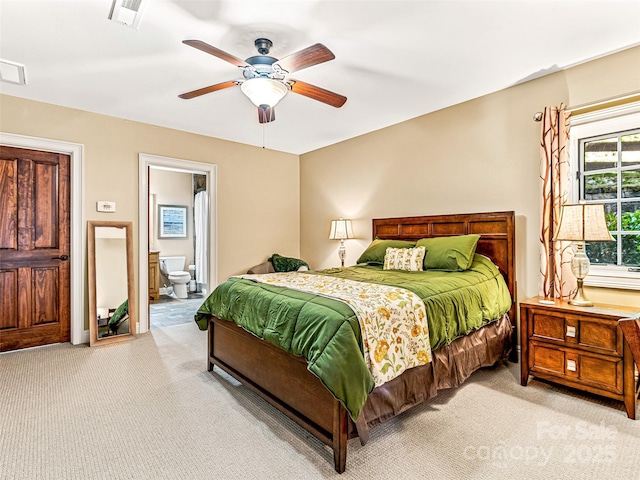 202 Emerald Ln, Maggie Valley, NC 28751 - bedroom featuring light carpet, connected bathroom, and ceiling fan