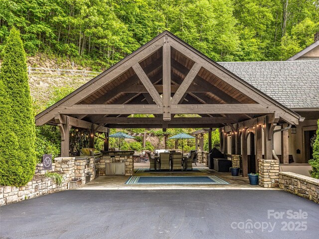 202 Emerald Ln, Maggie Valley, NC 28751 - view of car parking featuring a gazebo and a view of trees