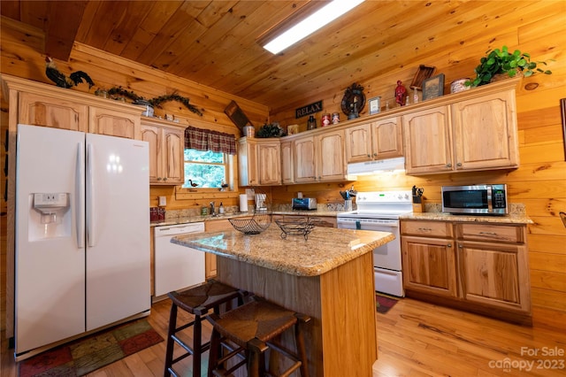 kitchen featuring a center island, white appliances, wood walls, wood ceiling, and light hardwood / wood-style flooring