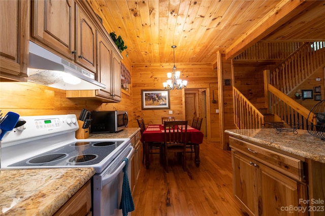 kitchen featuring white electric range, wooden walls, a chandelier, and dark wood-type flooring