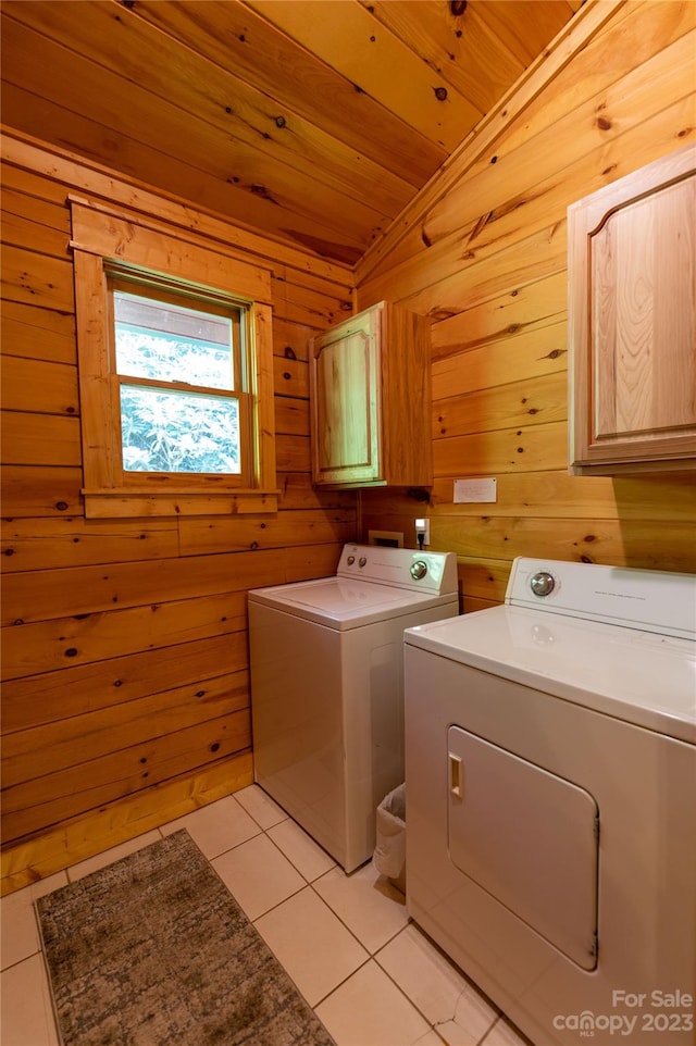 clothes washing area with light tile flooring, wood walls, independent washer and dryer, and wood ceiling