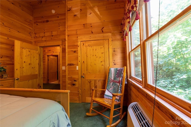 carpeted bedroom with wooden walls