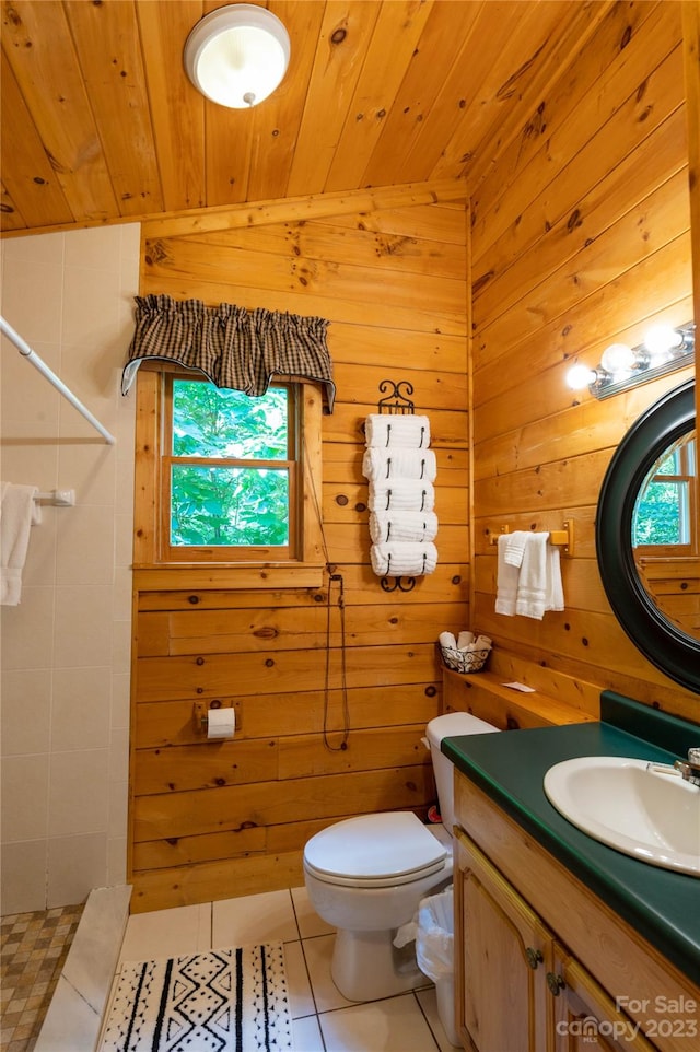 bathroom featuring toilet, wood ceiling, tile floors, wood walls, and vanity