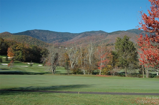 surrounding community with a lawn and a mountain view