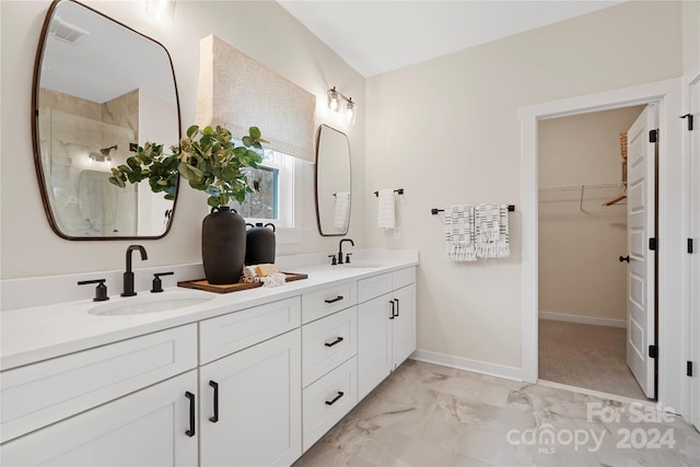 bathroom with a shower and vanity