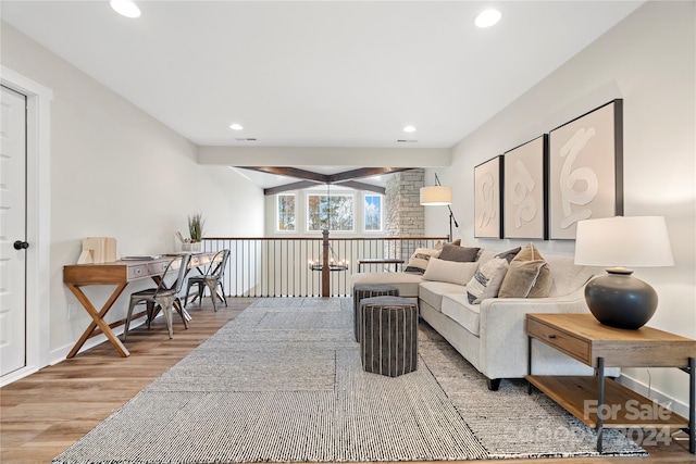 living room with beamed ceiling and wood-type flooring