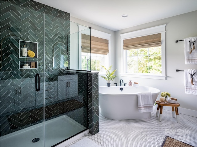 bathroom featuring tile patterned flooring and independent shower and bath