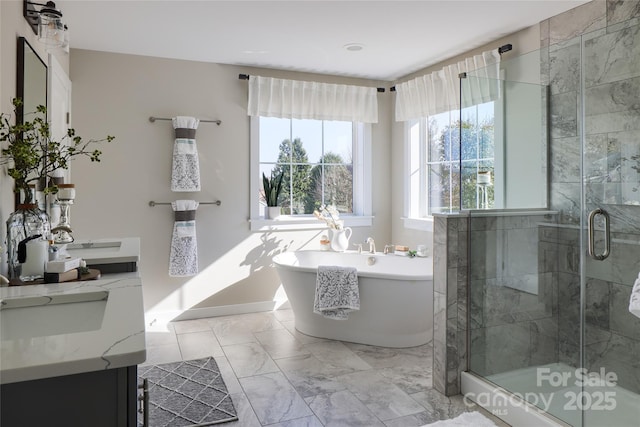11330 James Coy Rd Covington, Unit Covington, Davidson, NC 28036 - bathroom with vanity, a freestanding bath, a shower stall, and marble look tiles