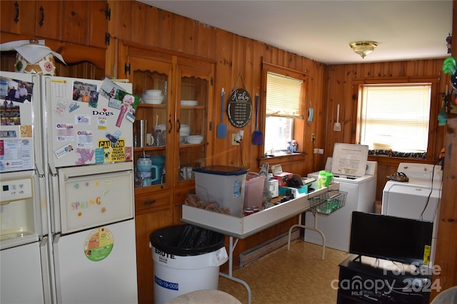 kitchen featuring wood walls, white refrigerator, and washer / dryer