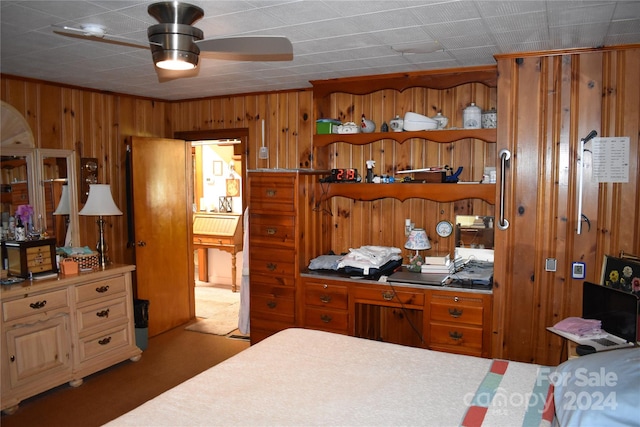 bedroom featuring wooden walls and carpet flooring