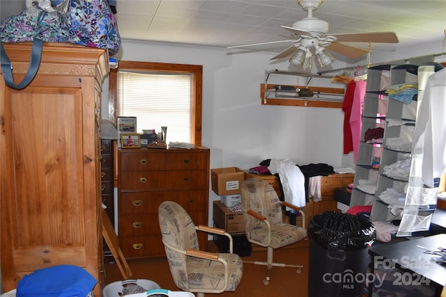 interior space with ceiling fan