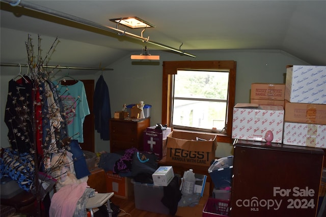 bedroom with vaulted ceiling and hardwood / wood-style flooring