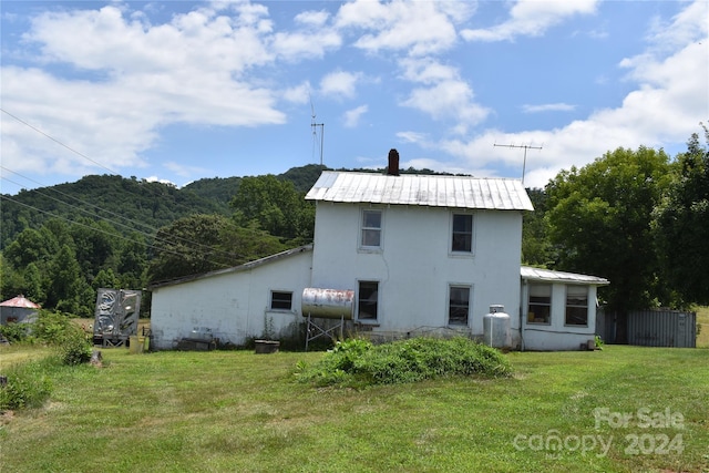 back of property with a yard