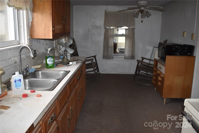 kitchen with decorative backsplash, sink, and ceiling fan