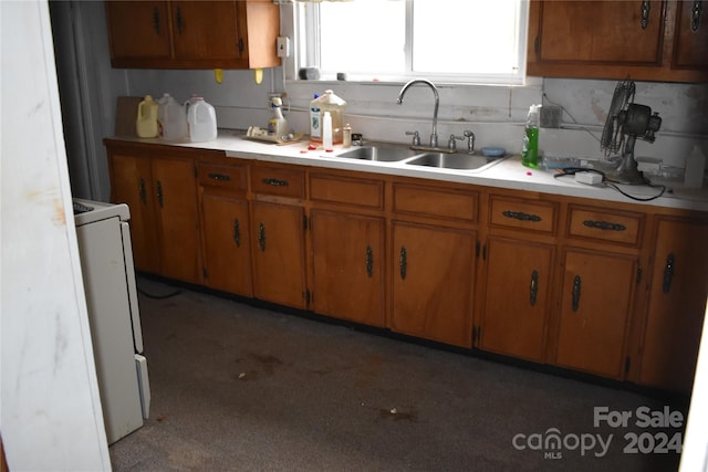 kitchen featuring sink and white stove