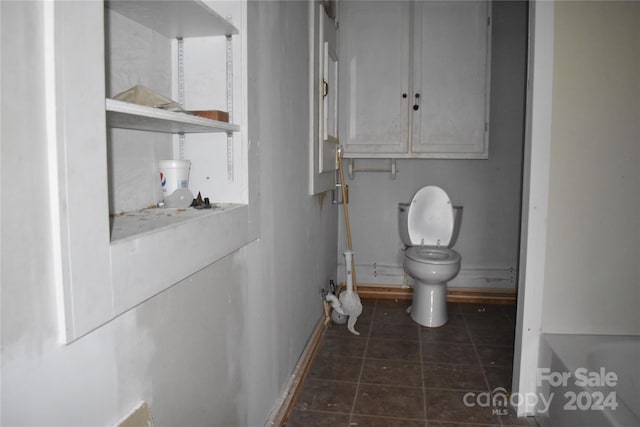 bathroom featuring tile patterned flooring and toilet